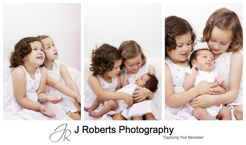 Older sisters holding their newborn baby sister - baby portrait photography sydney
